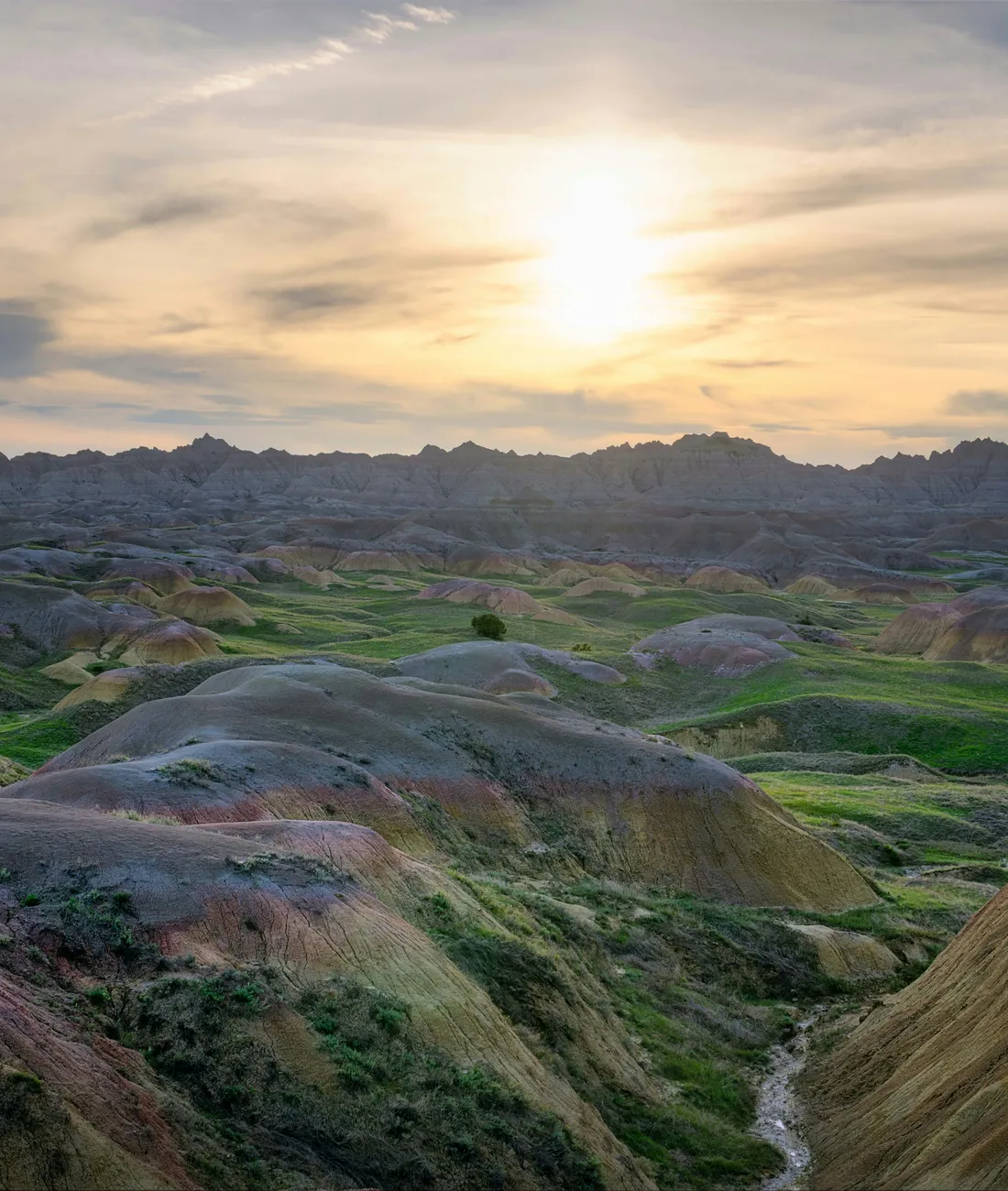 Sunrise over layered badlands terrain in South Dakota
